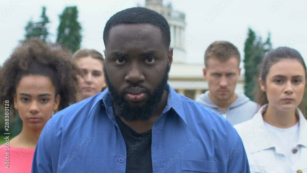 Afro-american man with multiethnic friends on silent rally for racial equality Afro-american man with multiethnic friends on silent rally for racial equality