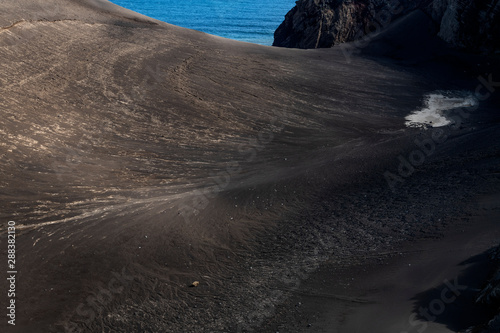 Abstract patterns and streams in new black lava land at Capelinhos volcano after the volcanic eruptions of 1957-58.