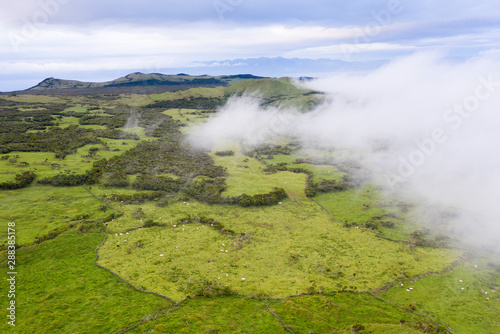 Aerial image of typical volcanic caldeira landscape with volcano cones of Planalto da Achada central plateau of Ilha do Pico Island