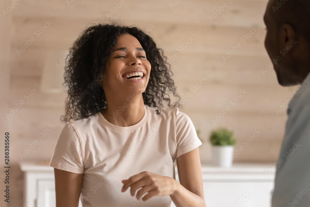 Fototapeta premium Happy african American woman laugh talking with husband