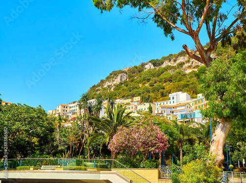 A typical street of Gibraltar with the Rock of Gibraltar in the background. View from Rosia Road. Gibraltar, British Overseas Territory, UK. photo