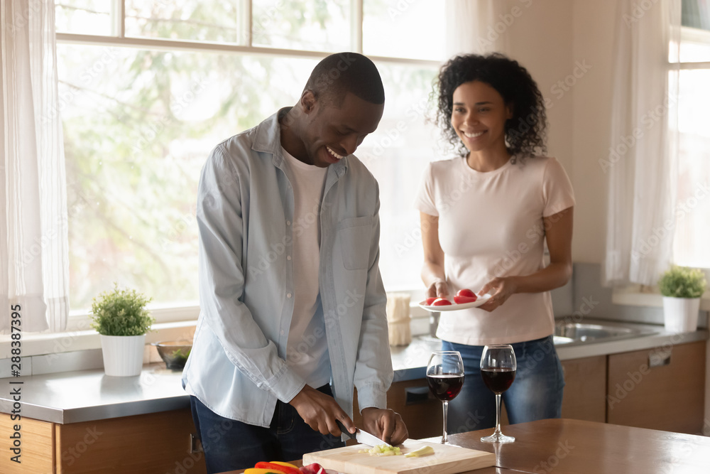 Happy african American couple cook food at home together Happy african American couple cook food at home together