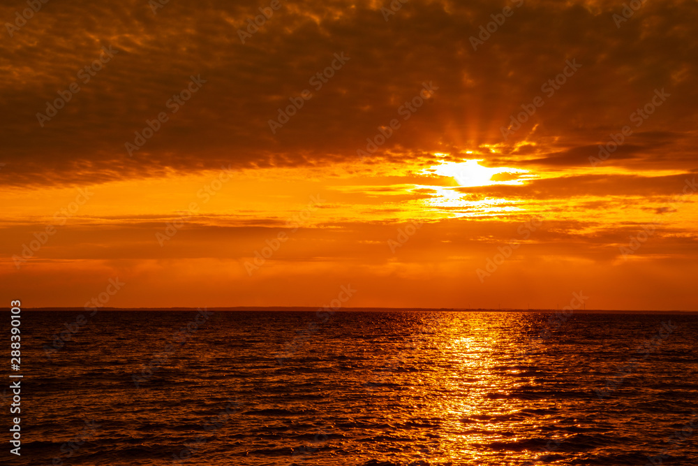Sunset on the island Öland with the swedish mainland on the horizon