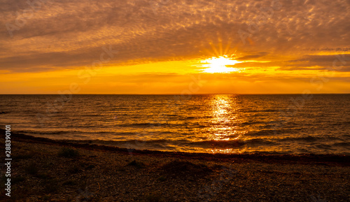 Sunset on the island Öland with the swedish mainland on the horizon