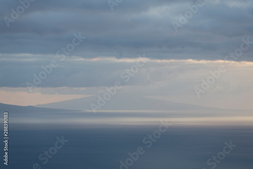 Landscape image showing cloud layers over Faial island as seen from Sao Jorge Island  Azores