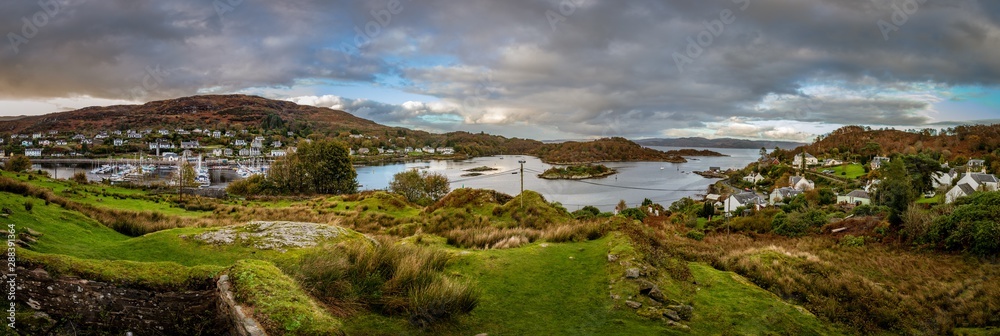 Sweeping panorama from the top of the hill next to Royal Castle Tarbert looking down at the bay and small city of Tarbert in Argyll and Bute Scotland United Kingdom
