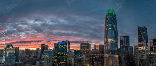 Beautiful orange, yellow and red sunset over the San Francisco skyline with a green tip on the tallest building