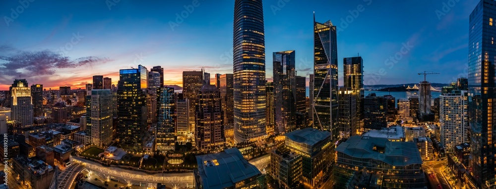 Blue hour with a pink sunset over San Francisco skyline with Salesforce Tower in the middle and Salesforce park at the bottom