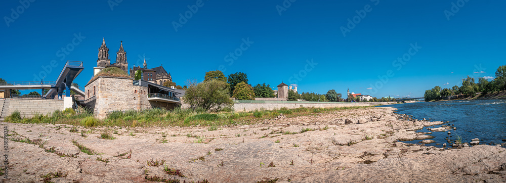 Panoramic view of Magnificent Cathedral of Magdeburg and river Elbe at Summer in Magdeburg, Germany, at sunny day and blue sky