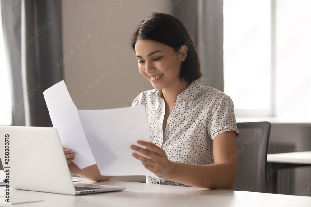 Smiling asian business woman satisfied with new project first results. Smiling asian business woman satisfied with new project first results.