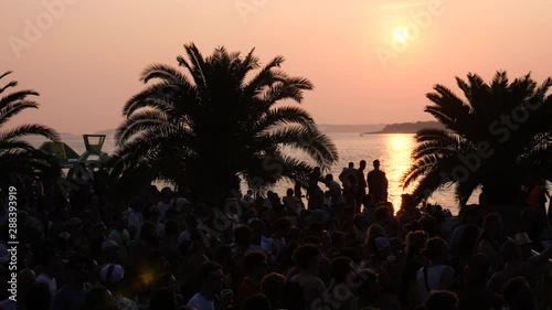  Silhouette crowd dancing at sunset