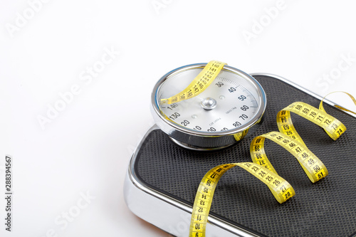 Tablou pe pânză Slim concept with scale and measuring tape on white background top view