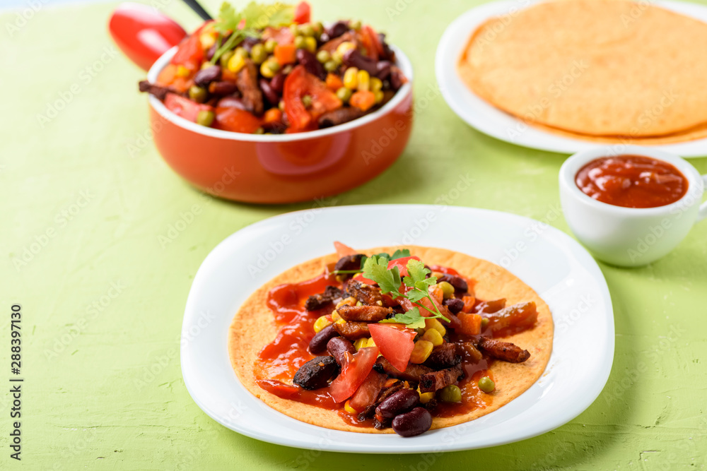Tacos - delicious tortillas with meat and vegetables Tacos - delicious tortillas with meat and vegetables