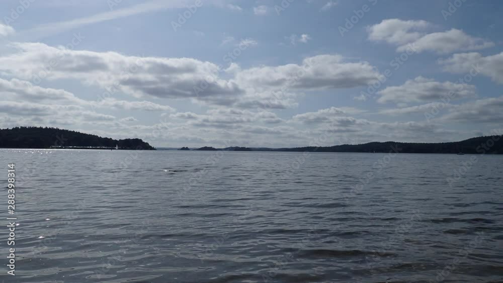 Soothing view of the lake mjorn with sailboats in the distance a beautiful summer day Soothing view of the lake mjorn with sailboats in the distance a beautiful summer day