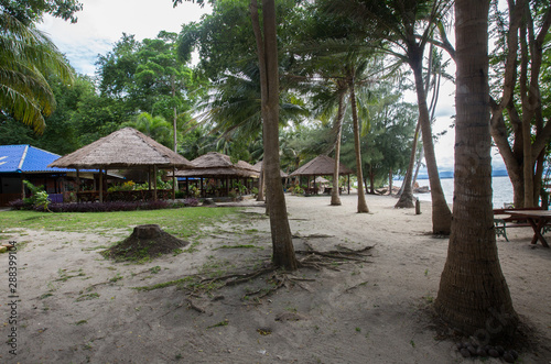 a traditonal Tahi bamboo pergola on the beach of Koh Talu, on a cloudy summer day
