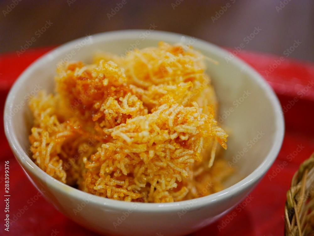 Selective focus of Thai sweeten crispy noodles ( Mee Krob ), Northern Thai snack served in a bowl Selective focus of Thai sweeten crispy noodles ( Mee Krob ), Northern Thai snack served in a bowl