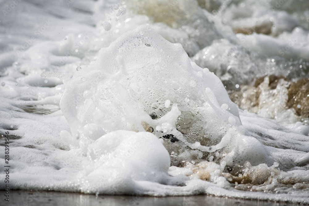 Close-up of Foamy Water Splashing onto Shore Close-up of Foamy Water Splashing onto Shore