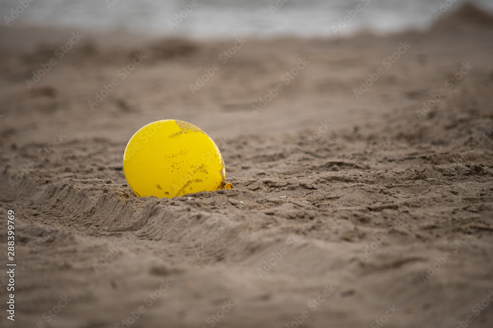 Yellow Balloon on Sand