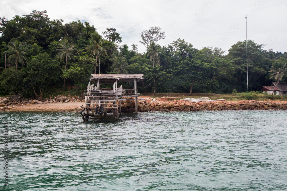 a rusty wooden boat dock in Koh Talu Island near Hua HIn Thailand a rusty wooden boat dock in Koh Talu Island near Hua HIn Thailand