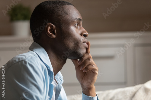 Profile view of pensive biracial man thinking of problem