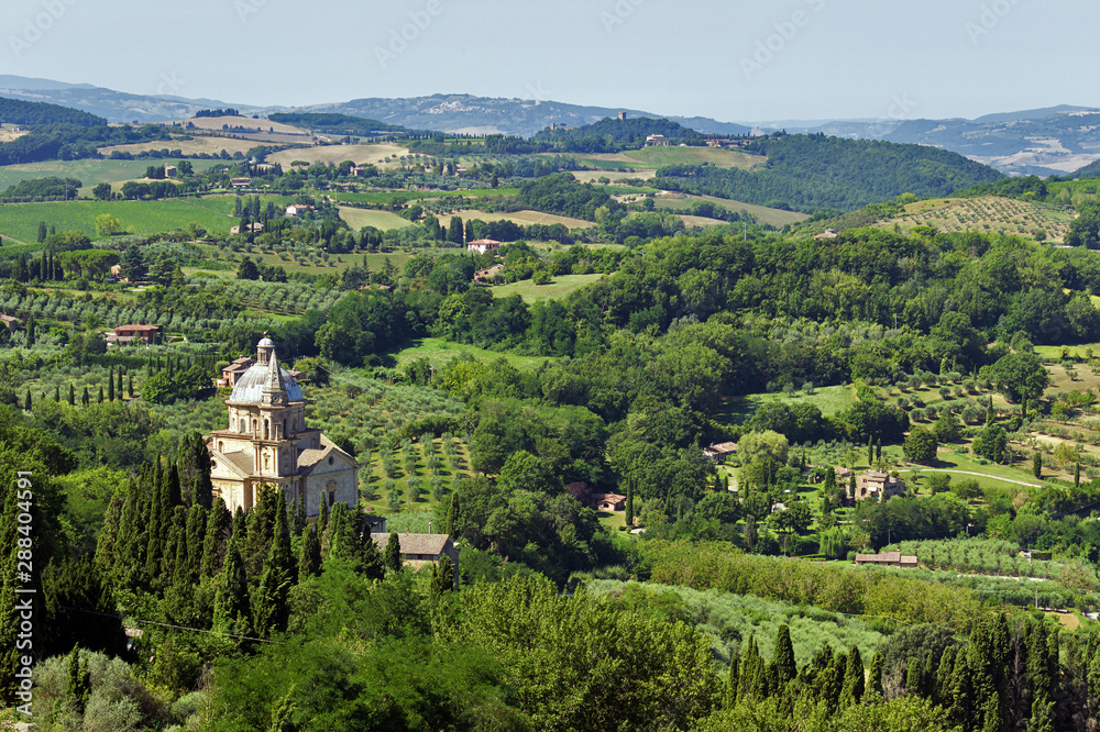 Panoramic view of the Tuscan hills of Montepulciano overlooking the christian temple of San Biagio