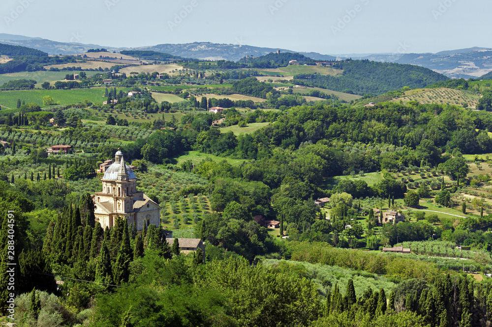 Naklejka premium Panoramic view of the Tuscan hills of Montepulciano overlooking the christian temple of San Biagio
