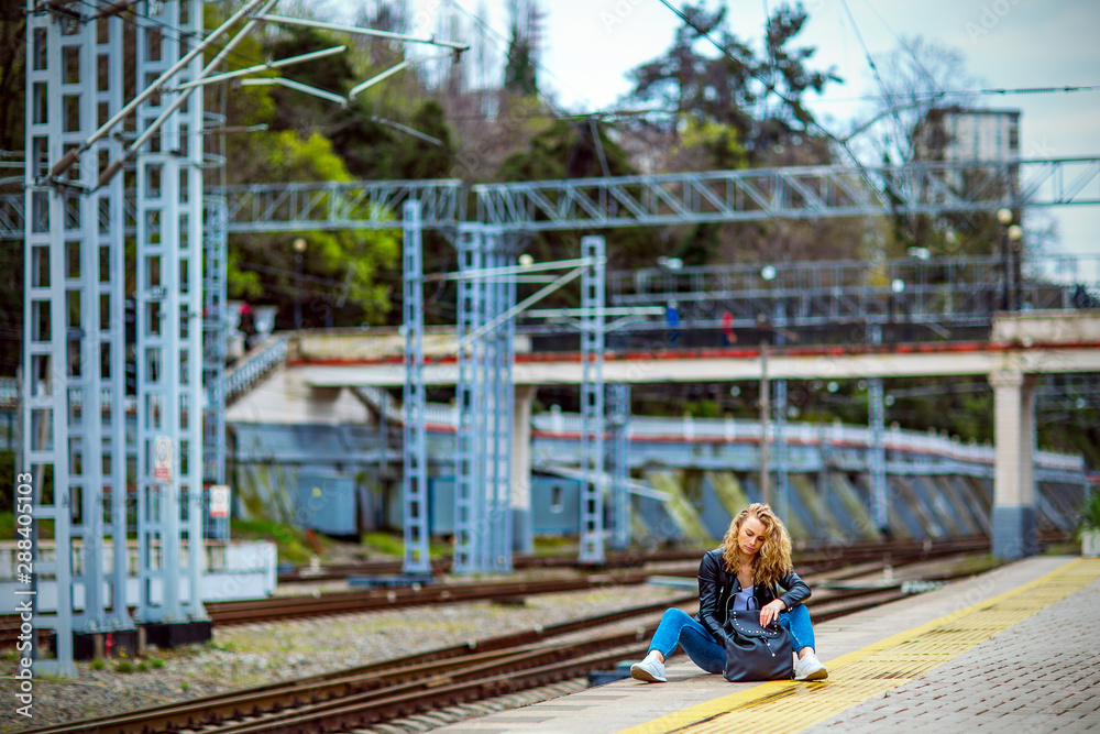 girl in a bad mood sitting at the station