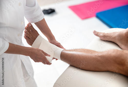 Female doctor holding a bandage for patient