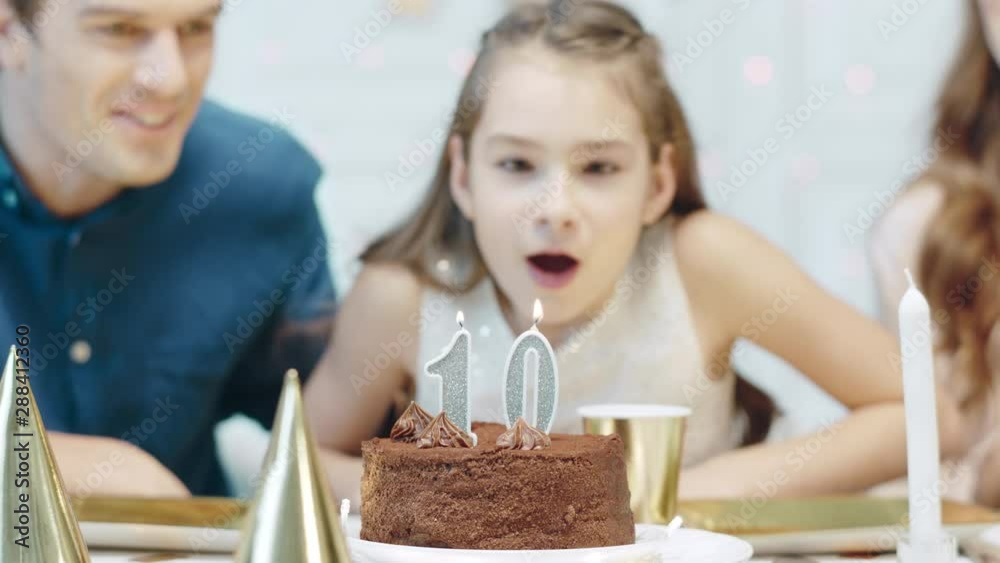 Portrait of smiling girl blowing birthday candles in luxury house. Portrait of smiling girl blowing birthday candles in luxury house.