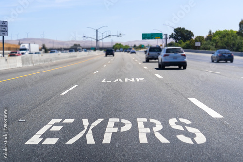 Express Lane marking on the freeway  San Francisco Bay Area, California  Express lanes help manage lane capacity by allowing single occupancy vehicles to use them for a fee © Sundry Photography
