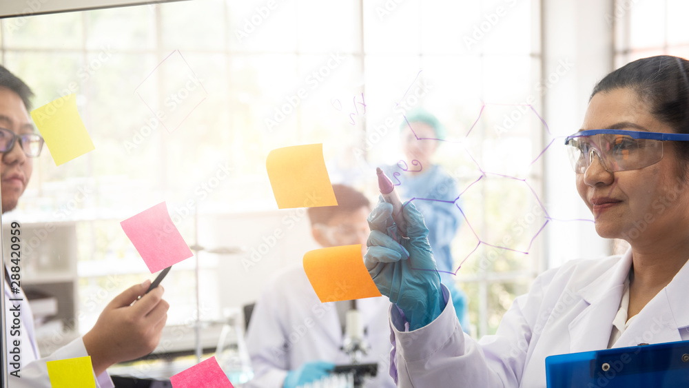 A group of scientists working in the laboratory while developing vaccines A group of scientists working in the laboratory while developing vaccines