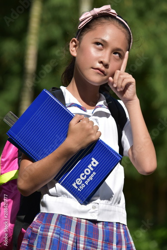 Thoughtful Catholic School Girl Wearing School Uniform With Notebooks
