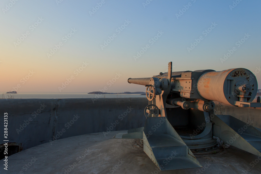 A gun on the Novosiltsevsky battery of the Russian island in Vladivostok at dawn.