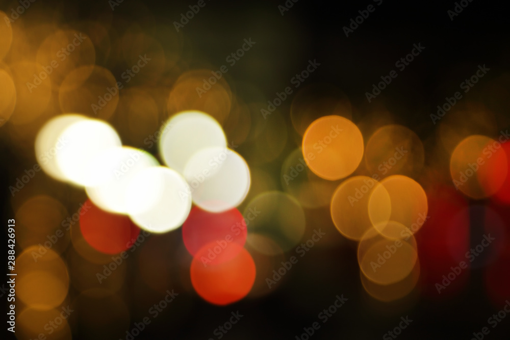 Fototapeta premium Blurry background image of defocused golden color abstract city street lights at night