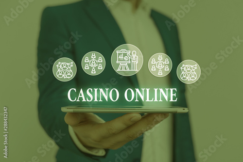 Text sign showing Casino Online. Business photo showcasing Computer Poker Game Gamble Royal Bet Lotto High Stakes Male human wear formal work suit presenting presentation using smart device photo