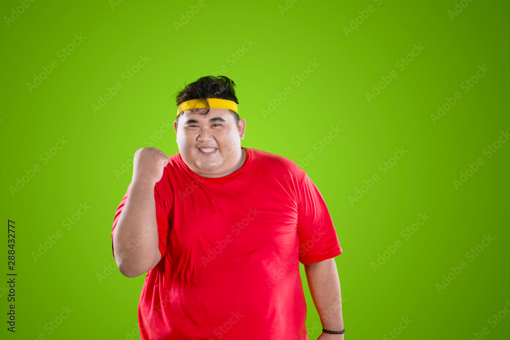 Fototapeta premium Fat man wears sportswear with happy expression
