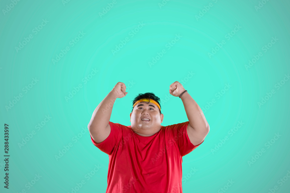 Naklejka premium Obese man expressing his success to lose weight