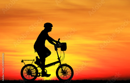 Silhouette  Cycling  on blurry sunrise  sky   background.