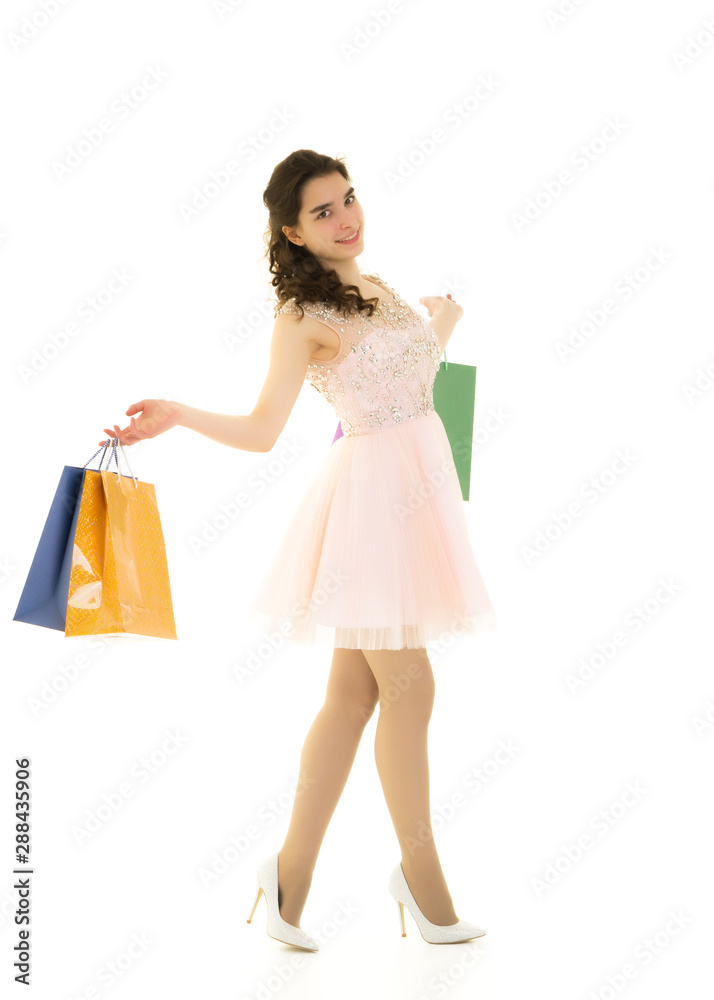Teenager girl shopping in a store with large paper bags. Teenager girl shopping in a store with large paper bags.
