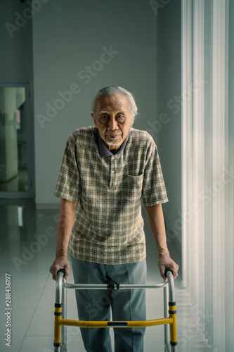 Senior man stepping with a walker