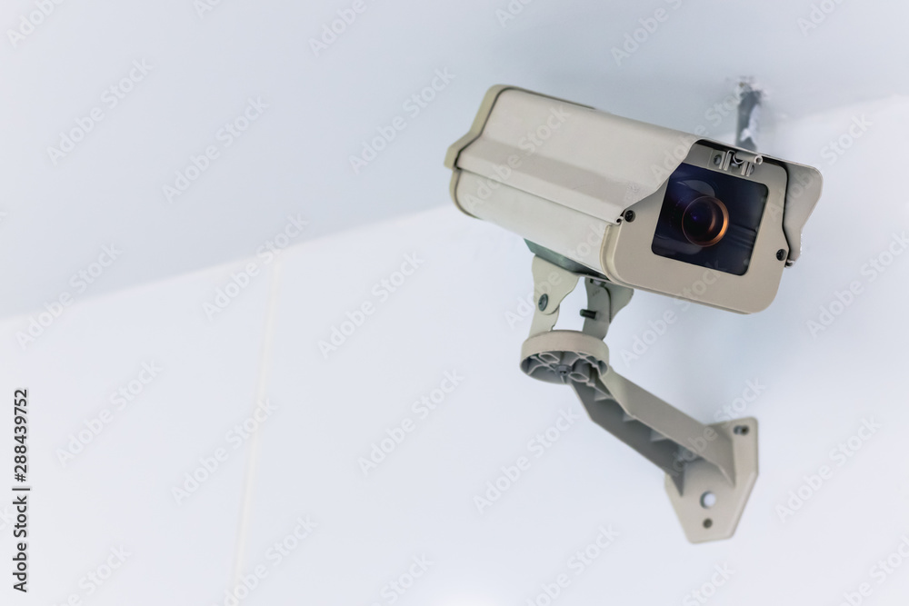 CCTV camera security technology system hang on the white wall with copy space