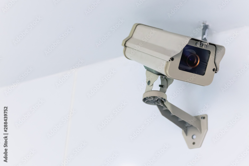 CCTV camera security technology system hang on the white wall with copy space CCTV camera security technology system hang on the white wall with copy space