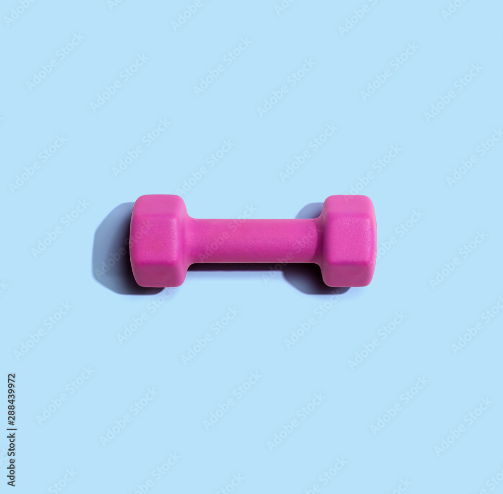 Dumbbell with hard shadow from above - overhead view Dumbbell with hard shadow from above - overhead view