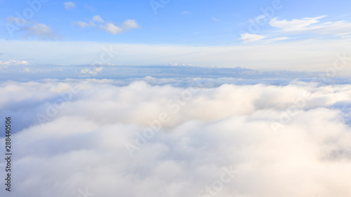 Fototapeta Naklejka Na Ścianę i Meble -  Aerial view White clouds in blue sky. Top view. View from drone. Aerial bird's eye view. Aerial top view cloudscape. Texture of clouds. View from above. Sunrise or sunset over clouds