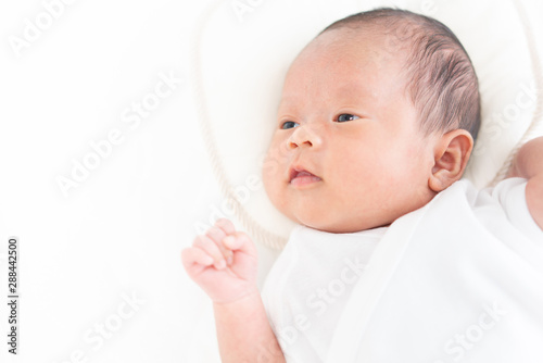 Baby lying on a crib