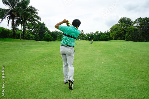 Blurred golfer playing golf in beautiful golf course in the evening golf course with sunshine in thailand © somchai