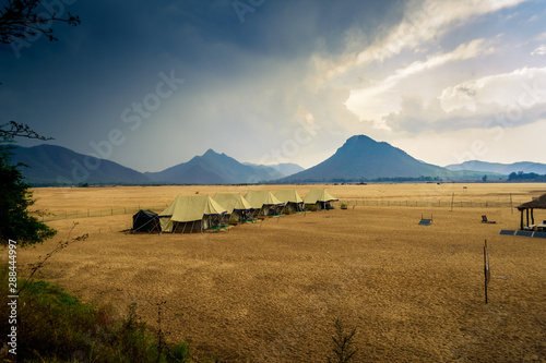Swiss tents in the sand surrounded by Eastern Ghat mountain range with copy space photo