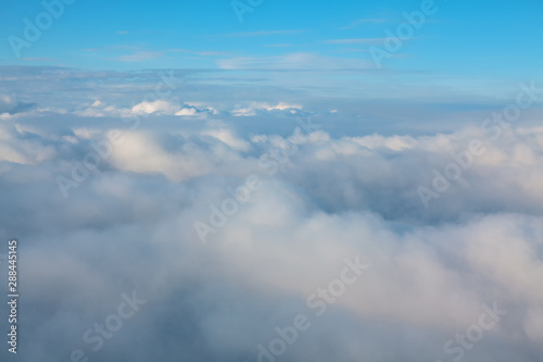 Fototapeta Naklejka Na Ścianę i Meble -   view of the of the cumulus clouds from the airplane window 