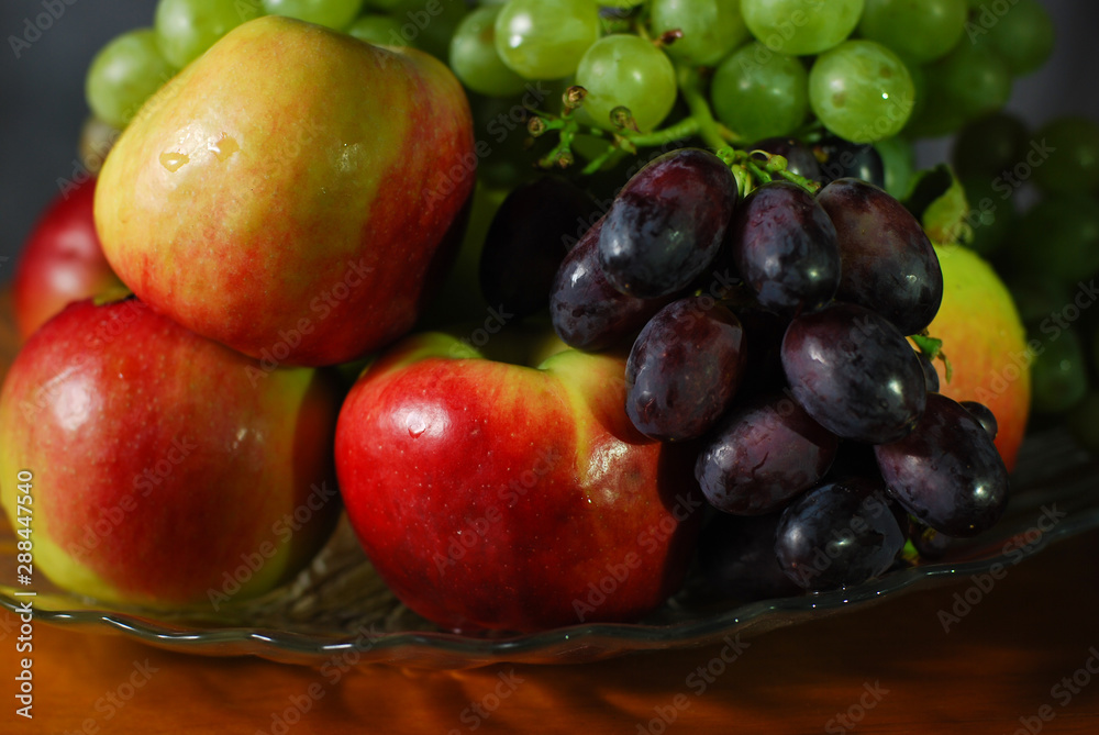 autumn still life red apples and ripe grapes of different varieties on a dish autumn still life red apples and ripe grapes of different varieties on a dish