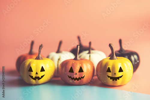 Halloween concept, Pumpkin with smile face on pastel colors background.